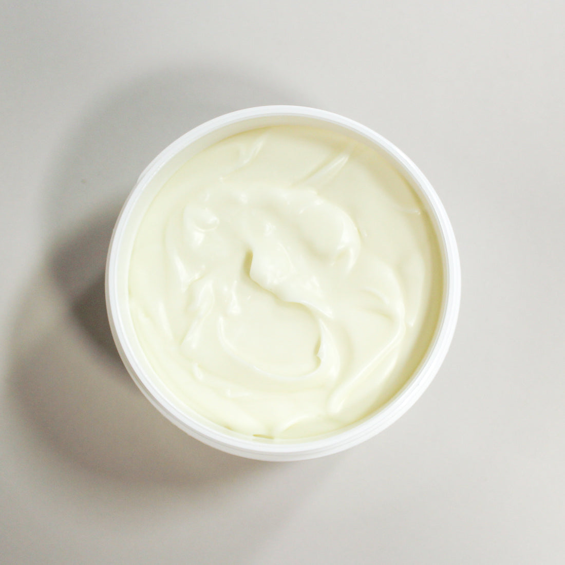 White container of a Butter Balm on a light gray background