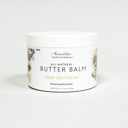 Jar of all-natural butter balm with a floral design on a white background