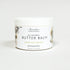 Jar of all-natural butter balm with a floral design on a white background