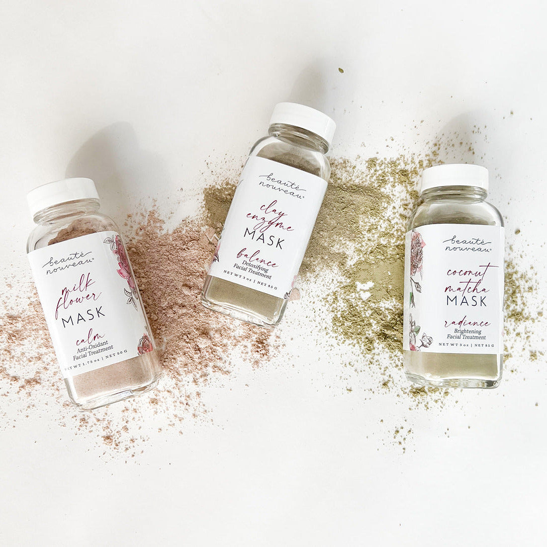 Three bottles of facial masks with visible labels on a light background