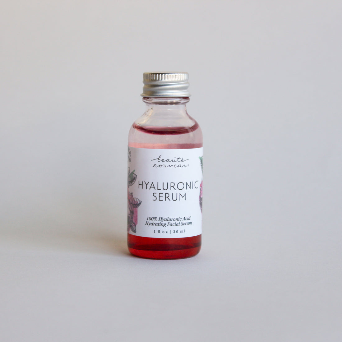 Red bottle with silver lid on a minimal background.