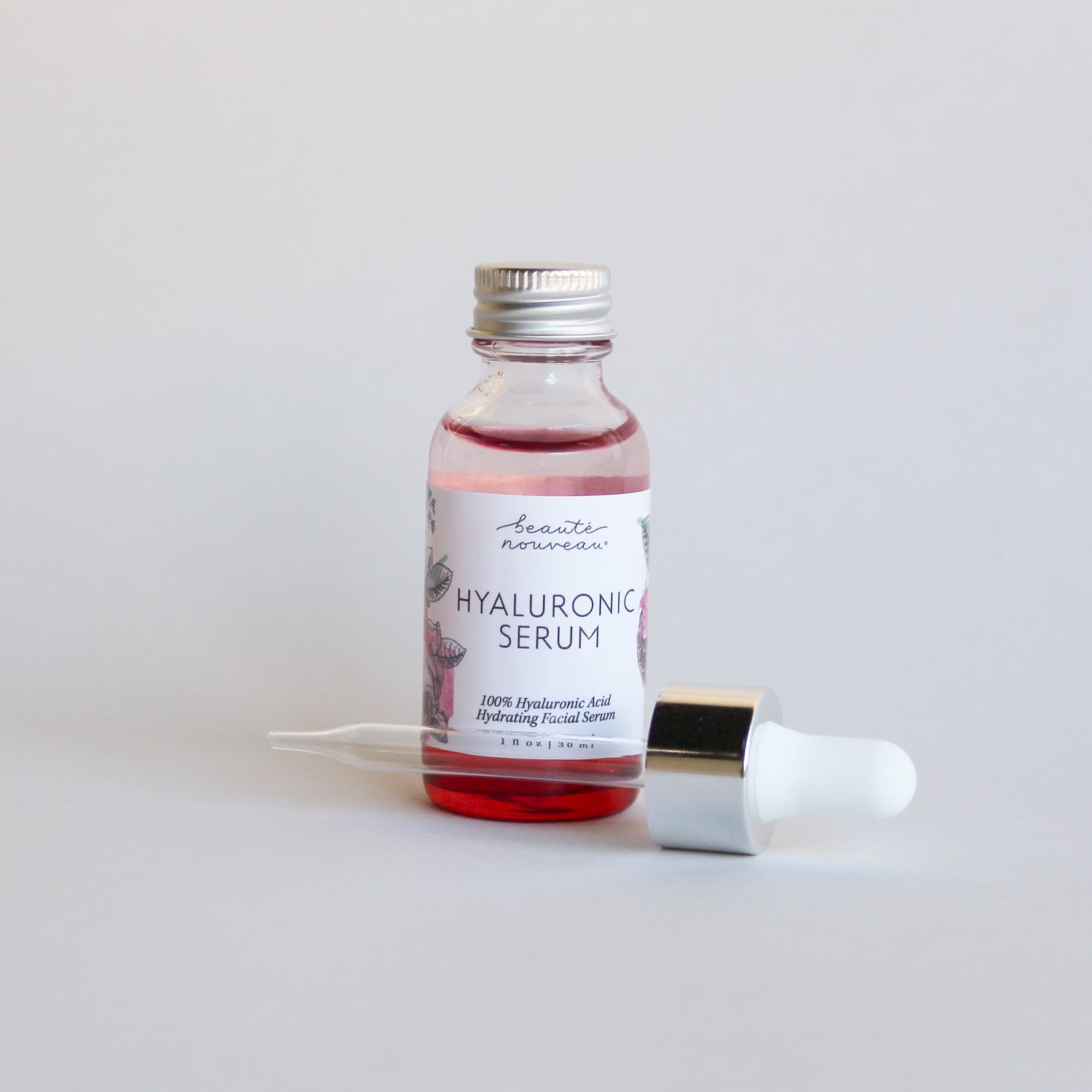 Red Hyaluronic Serum bottle on a minimal bakground.