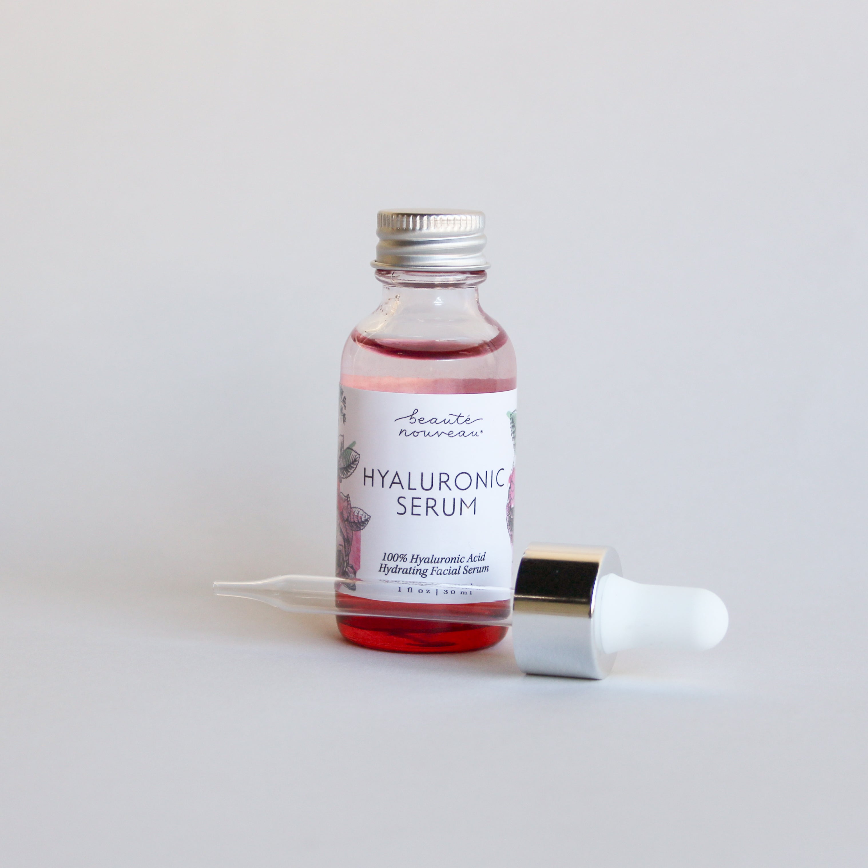 Red Hyaluronic Serum bottle on a minimal bakground.