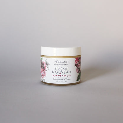 A jar of Crème Nouveau anti-aging face cream for dry, mature skin on  a light background.